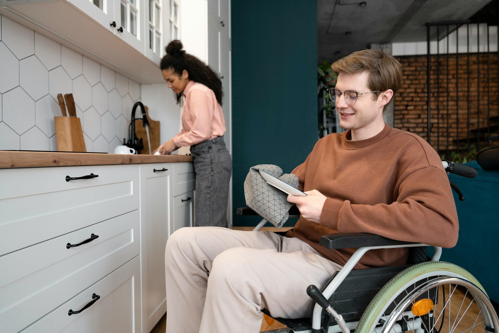 A man in a wheel chair in a kitchen